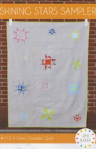 Shining Stars Sampler quilt pattern by Jeni Baker, scattered star blocks on a grey background
