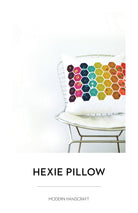 Hexie Pillow pattern by Modern Handcraft, white cushion with a rainbow hexagon panel